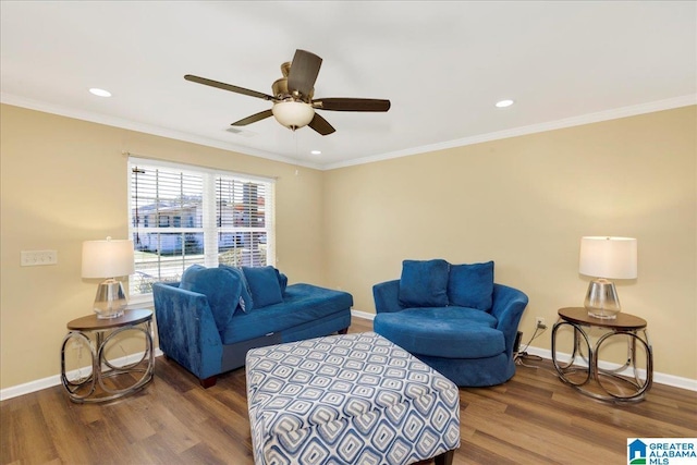 living room with ornamental molding, wood finished floors, and baseboards