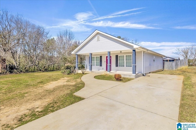 bungalow featuring covered porch, driveway, a front yard, and fence