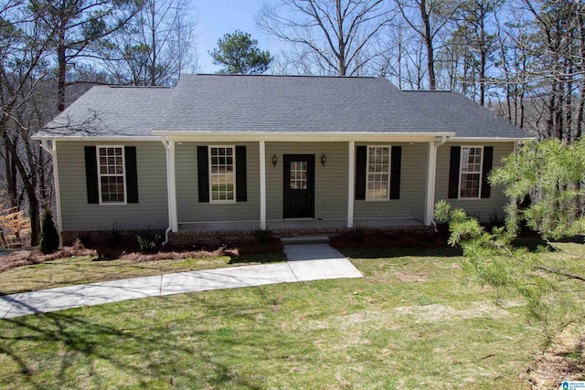 ranch-style house featuring a porch, roof with shingles, and a front lawn