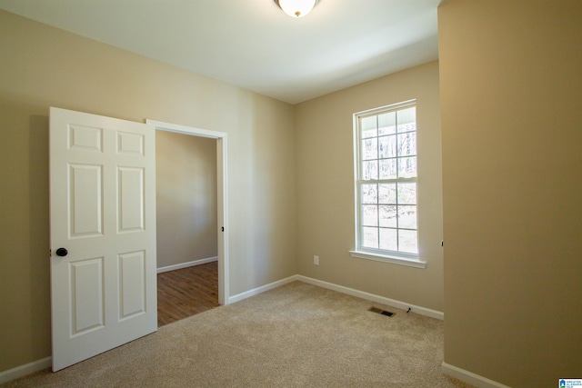 interior space with carpet, visible vents, and baseboards