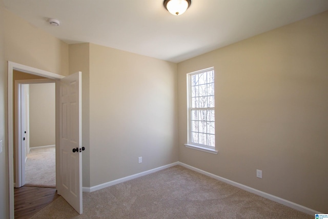 spare room with carpet flooring and baseboards