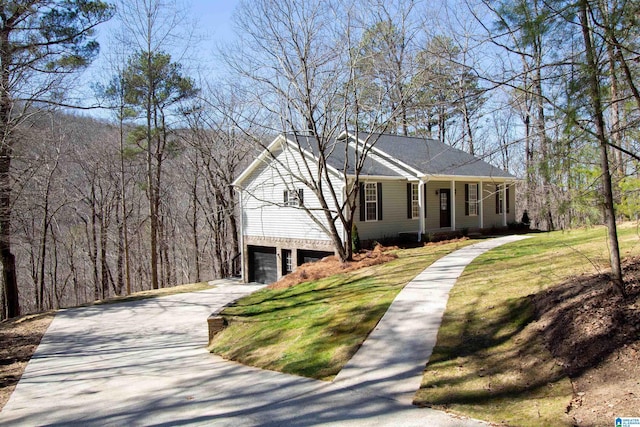 view of front of house with a garage, covered porch, a front lawn, and concrete driveway