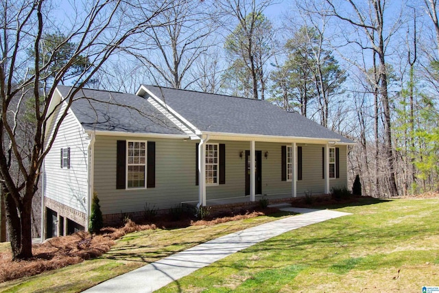 ranch-style house with covered porch, a shingled roof, and a front yard