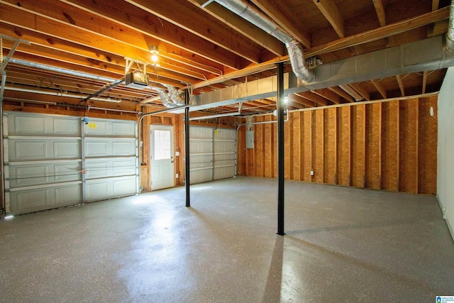 garage featuring a garage door opener and electric panel