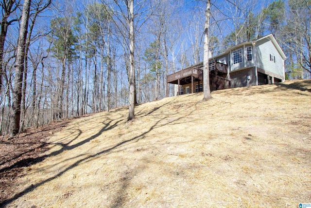 exterior space featuring brick siding and a wooden deck