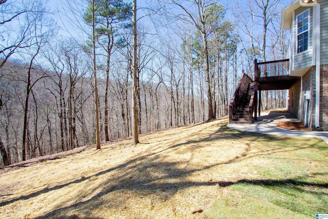 view of yard with stairway and a wooden deck