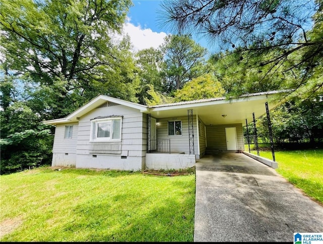 view of front of home featuring concrete driveway, a front yard, crawl space, metal roof, and a carport