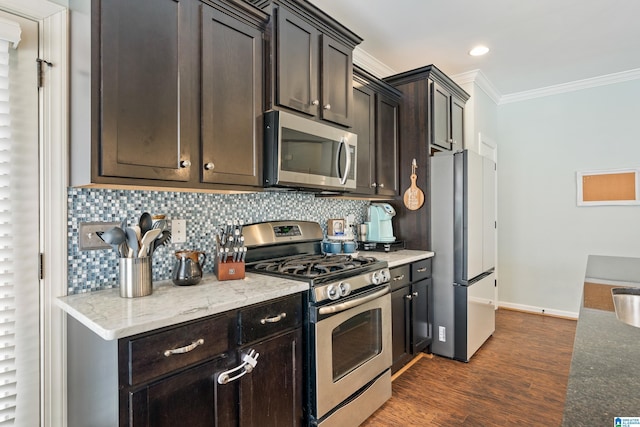 kitchen with ornamental molding, dark wood-style floors, tasteful backsplash, and stainless steel appliances