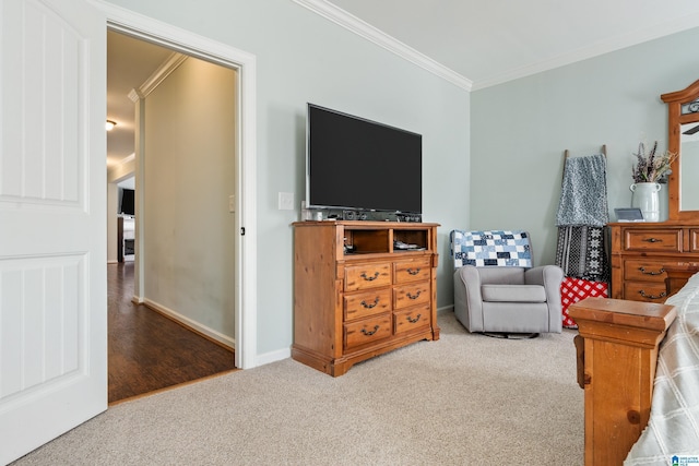 carpeted bedroom featuring baseboards and ornamental molding