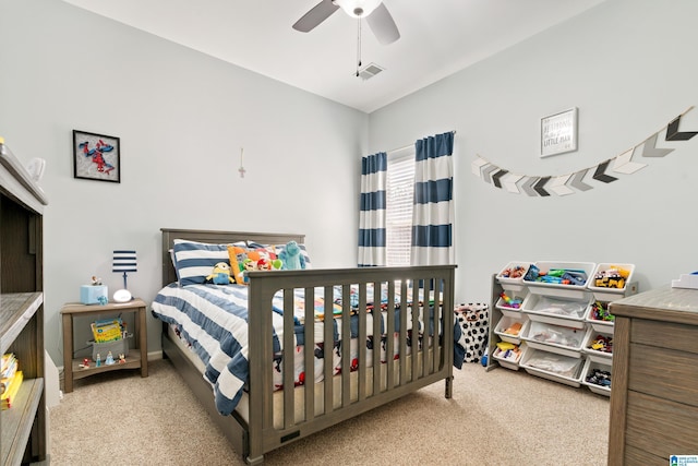 carpeted bedroom with visible vents and a ceiling fan