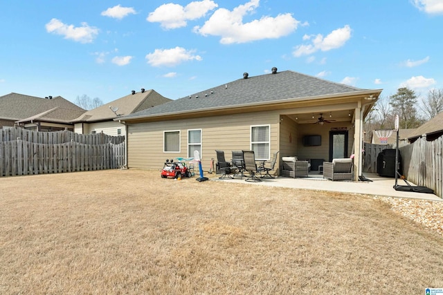 back of property with an outdoor hangout area, a patio area, a fenced backyard, and ceiling fan