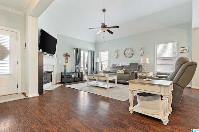 living room featuring ceiling fan, plenty of natural light, wood finished floors, and a tile fireplace