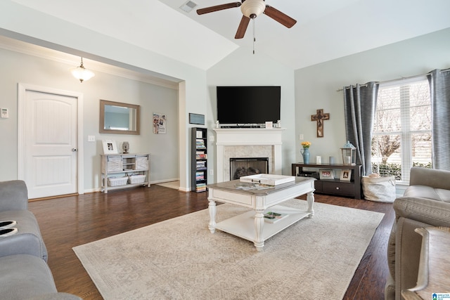 living area featuring a fireplace, wood finished floors, a ceiling fan, and vaulted ceiling