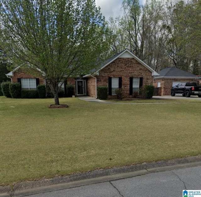 ranch-style home with brick siding and a front yard