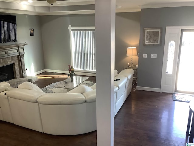 living room with a wealth of natural light, a fireplace, baseboards, and wood finished floors