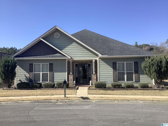 view of front of home featuring roof with shingles