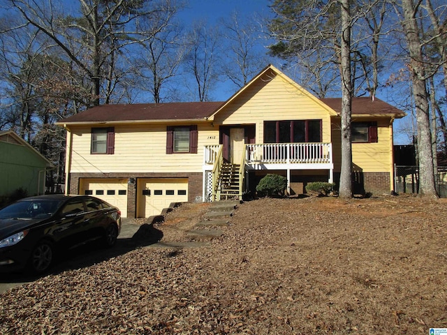 view of front of house with a porch, brick siding, stairway, and an attached garage