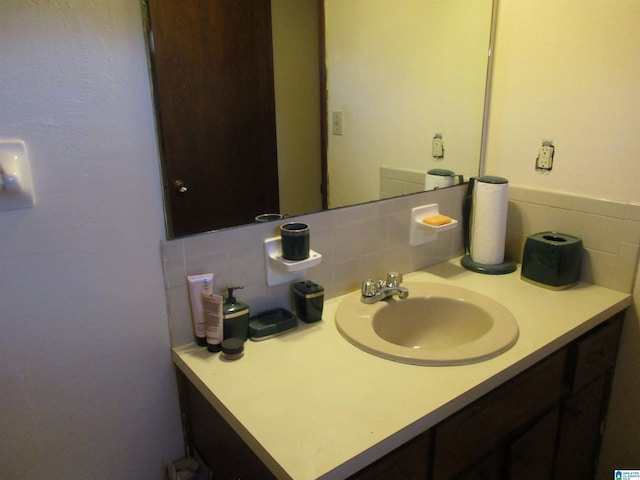 bathroom featuring tasteful backsplash and vanity