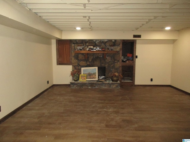 finished basement with visible vents, baseboards, and wood finished floors