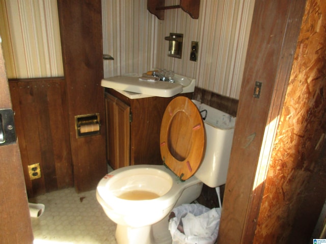 half bathroom with vanity and toilet