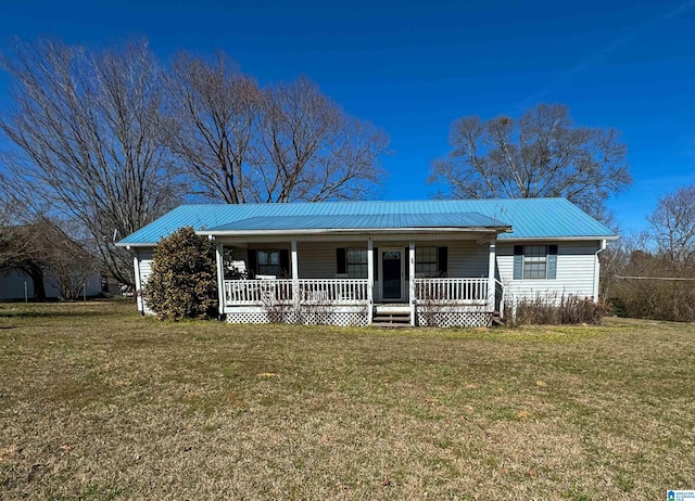 single story home featuring covered porch, metal roof, and a front yard