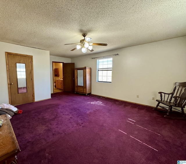 unfurnished bedroom with carpet floors, a textured ceiling, and baseboards