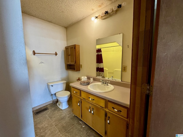 bathroom featuring a textured ceiling, tile patterned flooring, toilet, vanity, and visible vents