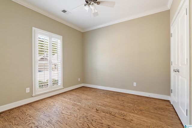 unfurnished room with wood finished floors, visible vents, baseboards, a ceiling fan, and ornamental molding