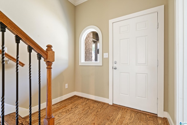 entryway featuring stairway, baseboards, and wood finished floors