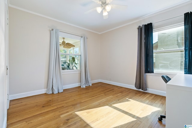 empty room with ornamental molding, baseboards, ceiling fan, and light wood finished floors