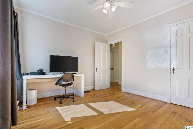 home office with light wood-style floors, crown molding, and baseboards