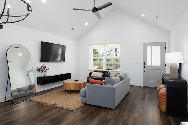 living area with dark wood-style floors, visible vents, high vaulted ceiling, and ceiling fan with notable chandelier