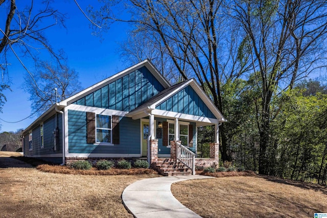 craftsman inspired home featuring a porch and board and batten siding