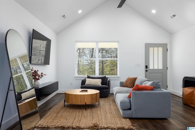 living room featuring high vaulted ceiling, wood finished floors, visible vents, and baseboards