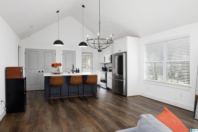 kitchen featuring white cabinets, dark wood-style floors, stainless steel appliances, and light countertops