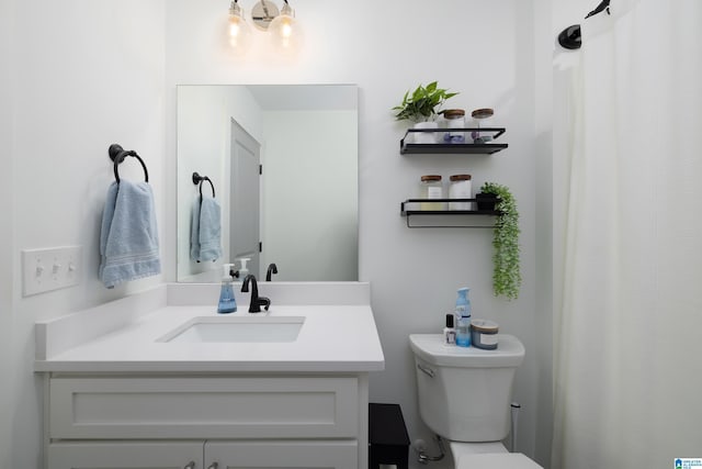 bathroom with toilet and vanity