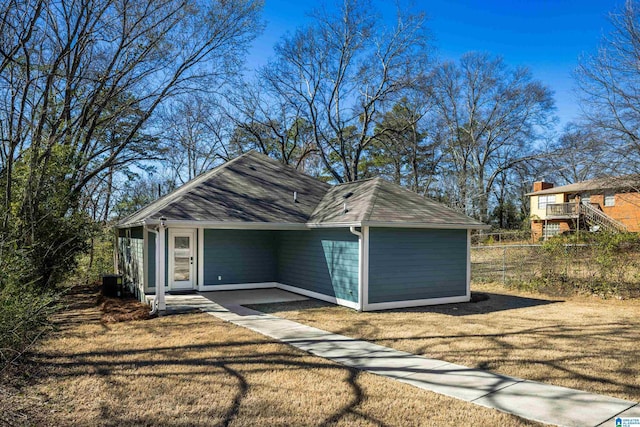 garage with central AC unit and fence