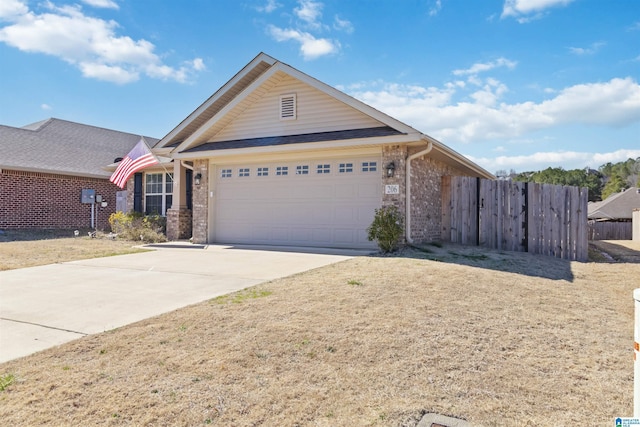 view of front facade featuring a garage, brick siding, driveway, and fence