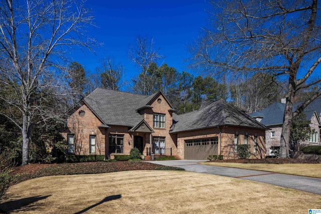 view of front facade featuring concrete driveway, brick siding, and an attached garage