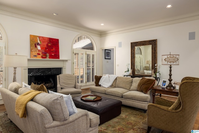 living room featuring recessed lighting, wood finished floors, a high end fireplace, and crown molding