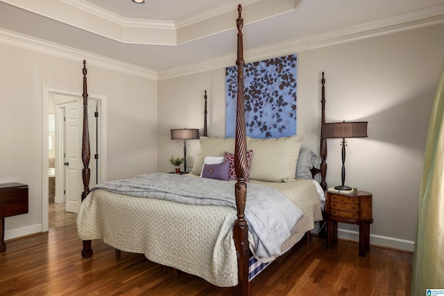 bedroom featuring ornamental molding, wood finished floors, a raised ceiling, and baseboards