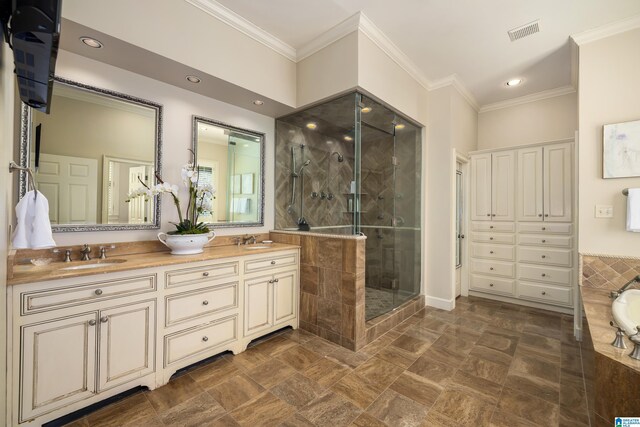 full bathroom with ornamental molding, a stall shower, a sink, and visible vents