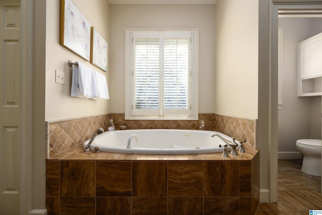 bathroom featuring a garden tub and toilet