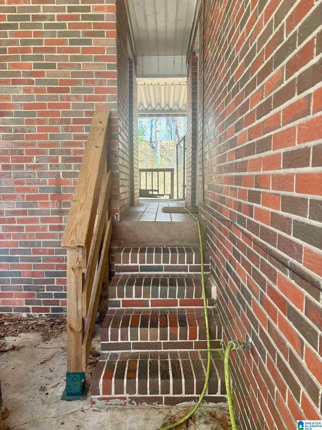 staircase with brick wall