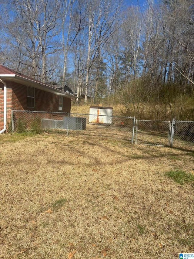 view of yard featuring fence and a gate