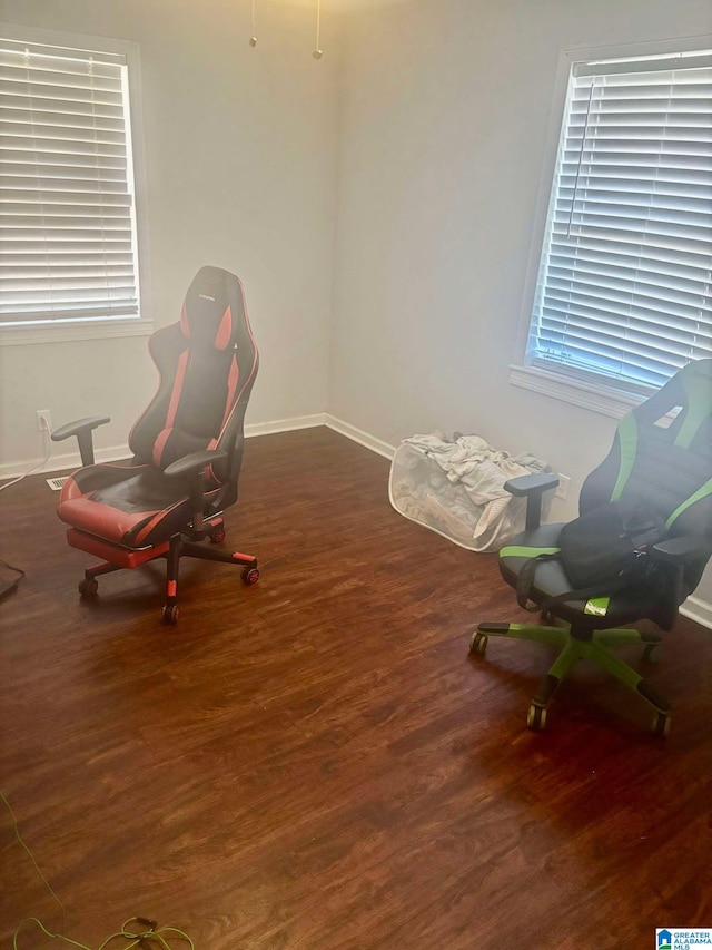 sitting room featuring dark wood-type flooring and baseboards