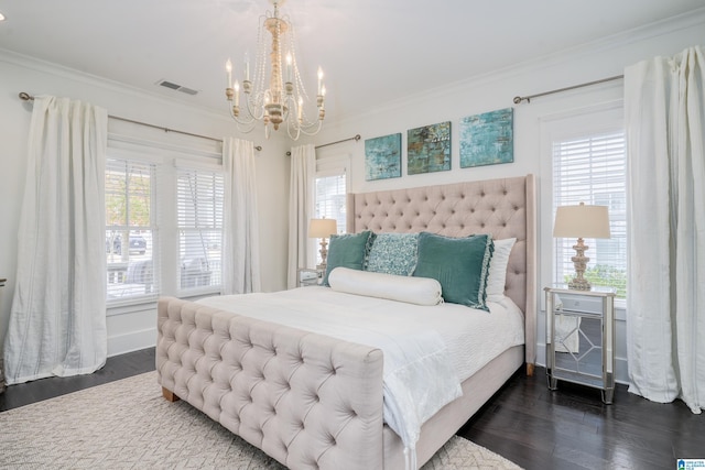 bedroom featuring dark wood-style floors, visible vents, multiple windows, and ornamental molding