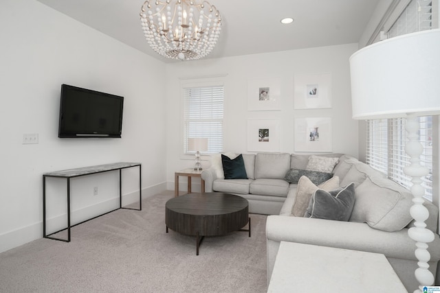 carpeted living room with baseboards, a chandelier, and recessed lighting