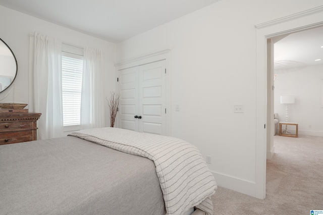 bedroom featuring a closet, carpet flooring, and baseboards