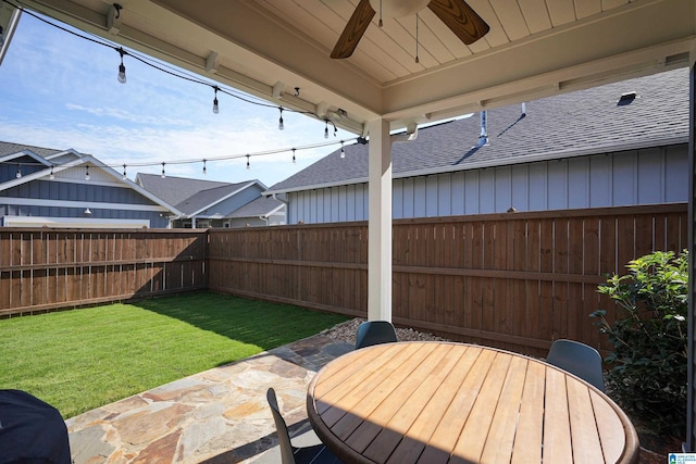 view of patio with outdoor dining space, a fenced backyard, and ceiling fan